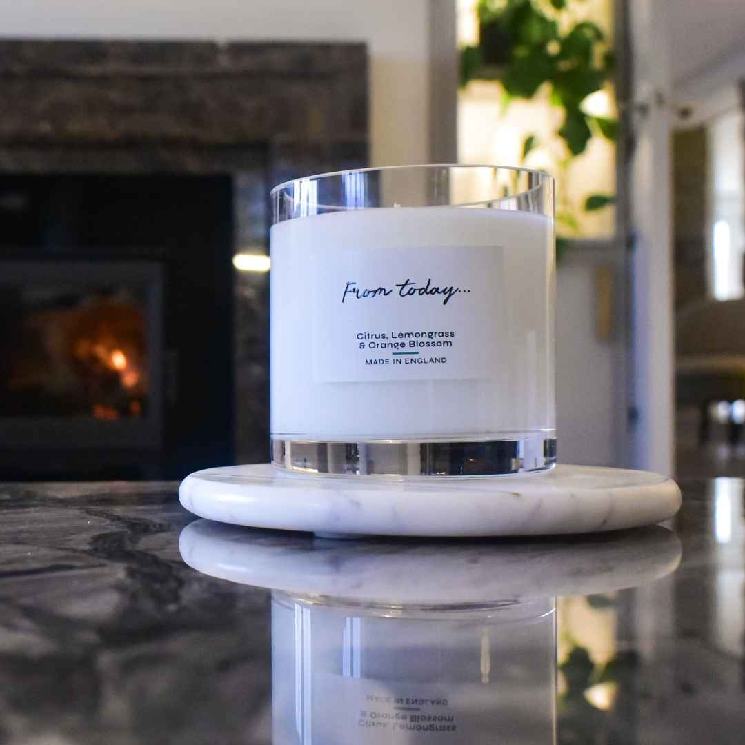 Luxury scented candle in Citrus, Lemongrass & Orange Blossom on marble coffee table