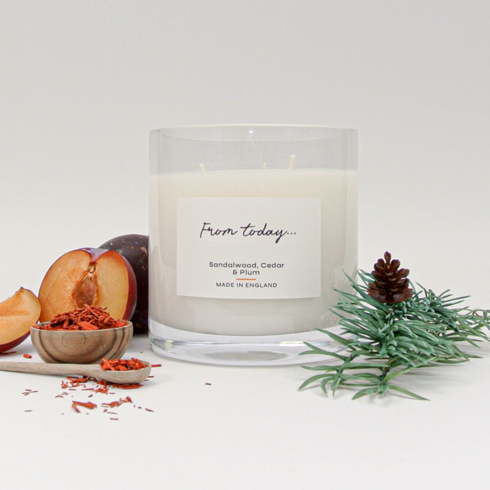 Luxury 3 wick candle in Sandalwood, Cedar & Plum pictured with the fragrance ingredients