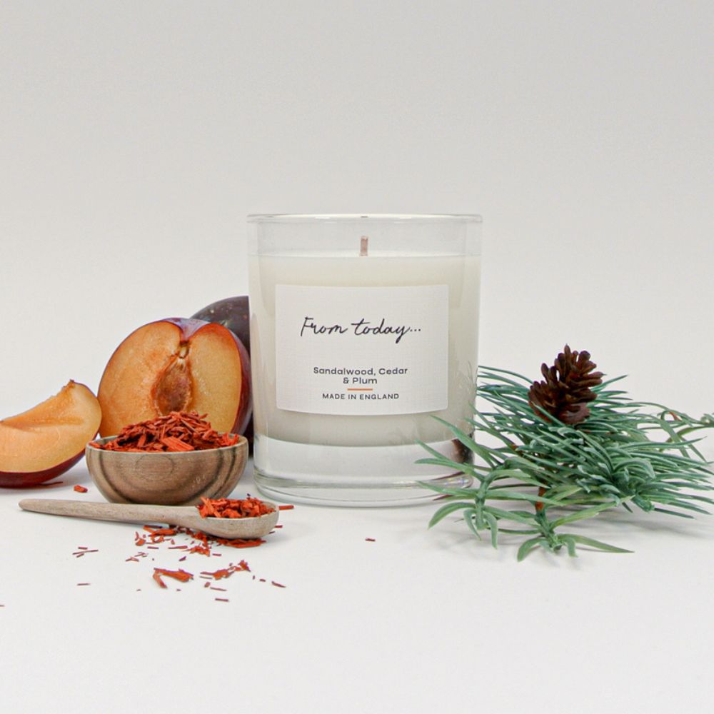Luxury Sandalwood Cedar & Plum Candle pictured with the fragrance ingredients